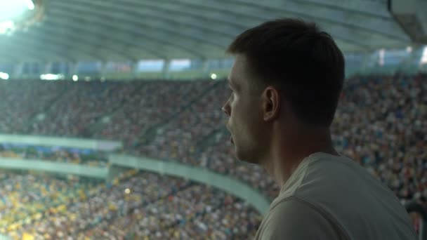 Sport fan frustrated with losing game, watching match or races at stadium - Filmmaterial, Video
