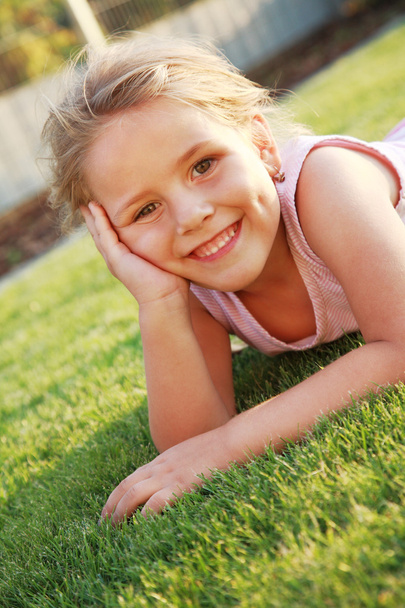 Happy girl relaxing on a grass - Photo, image