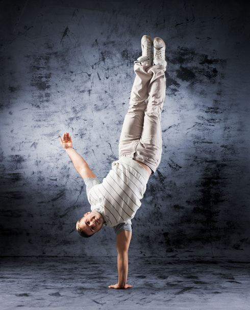A young and fit dancer in modern clothes performing - Foto, Imagen