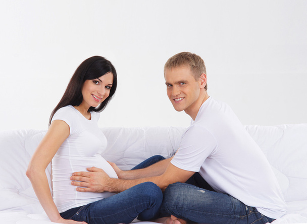 Young attractive couple: pregnant mother and happy father - Фото, изображение