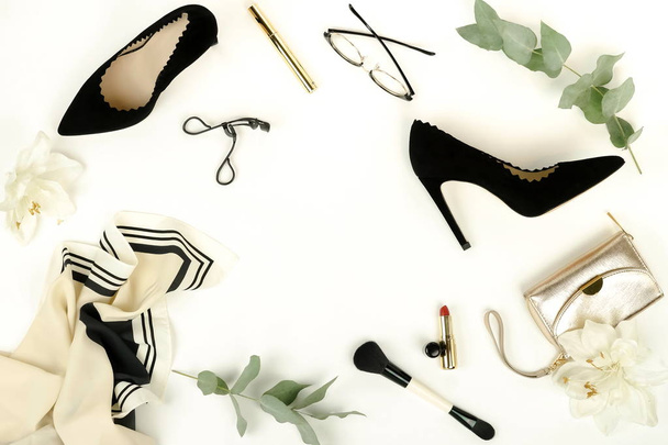 Flat lay, top view female black shoes with heels, accessories and make up cosmetics. bag, headscarf, glasses, lipstick, mascara, powder, brush, parfume on a white background.  Copy space. - Photo, image