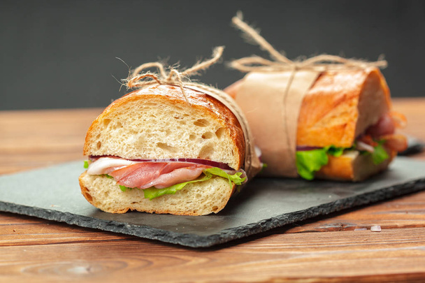 close up of sandwiches on a wooden table - 写真・画像
