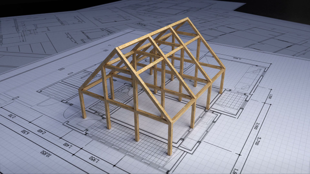 Houten frame maken van huis op architectonisch ontwerp plan papier. - Video