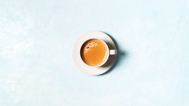 Top view of cup of coffee espresso on blue pastel background - Foto, Imagem