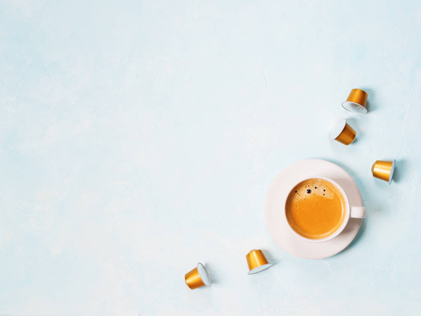cup of coffee espresso with capsules on blue pastel background - Foto, immagini