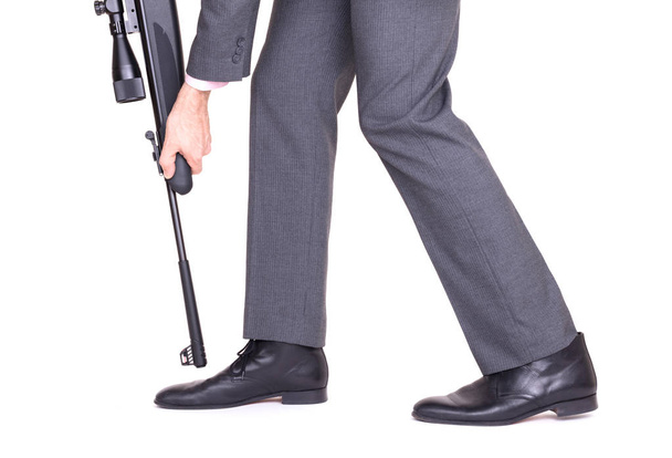 Concept - Businessman shooting himself in the foot with a rifle - Photo, Image