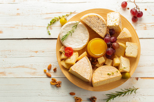 close up of different types of cheese on wooden table - Valokuva, kuva