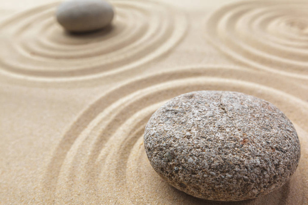 Close up of zen garden with sand and stones  - Foto, afbeelding