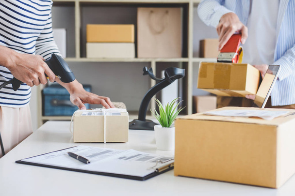 Kisvállalkozás tulajdonos szállítási szolgáltatás és dolgozó csomagolás doboz, a tulajdonos dolgozik ellenőrzése érdekében, hogy ellenőrizze, mielőtt elküldi az ügyfél postahivatalban, Szállítás Online értékesítés. - Fotó, kép