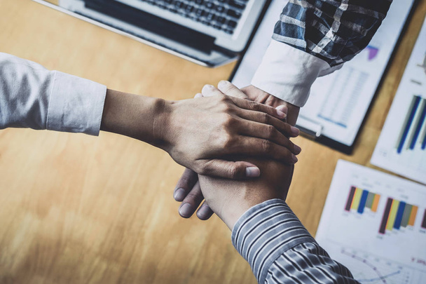 Business team shaking hands of unity after a meeting to sign agreement and become partner in the office, contract between their firms. - Фото, изображение