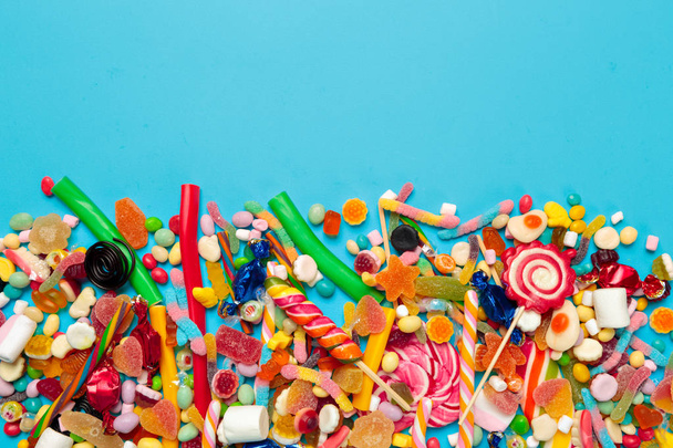 colored candies on blue background - Fotó, kép