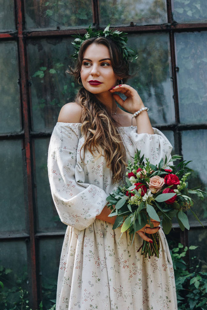 Beautiful bride with bouquet in botanical garden - Photo, image