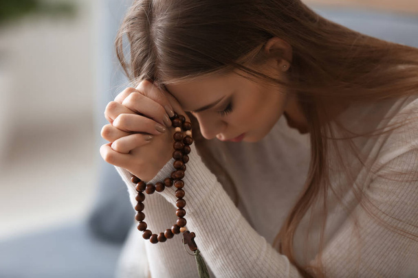 Beautiful young woman praying at home - Фото, зображення