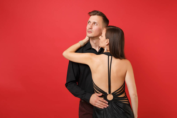 Fashionable young couple in black clothes shirt dress celebrating birthday holiday party isolated on bright red background. St. Valentine International Women Day Happy New Year 2019 concept. Mock up - Photo, Image