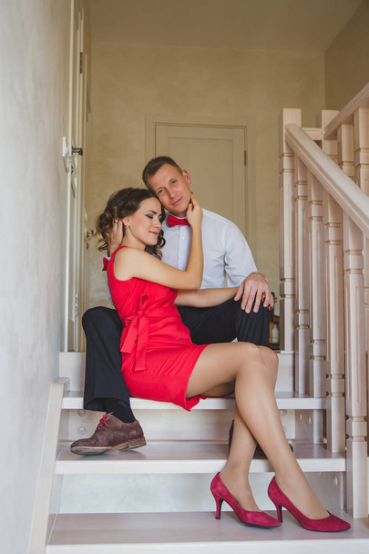 Beautiful young couple in love posing on staircase  - Valokuva, kuva