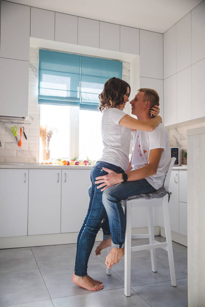 Beautiful young couple in love in the kitchen  - Fotoğraf, Görsel