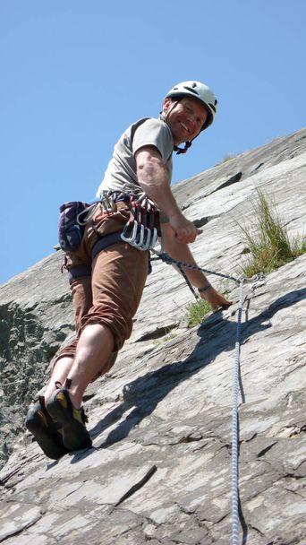 alpiniste guide de montagne sur un chemin d'escalade calcaire dalle dans les Alpes de Suisse par une belle journée
 - Photo, image