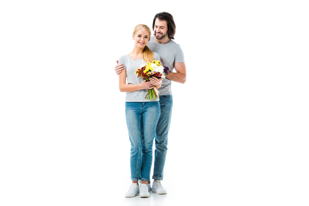 Happy couple hugging and girl holding flowers isolated on white - Valokuva, kuva