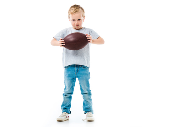 Little boy holding rugby ball isolated on white - 写真・画像