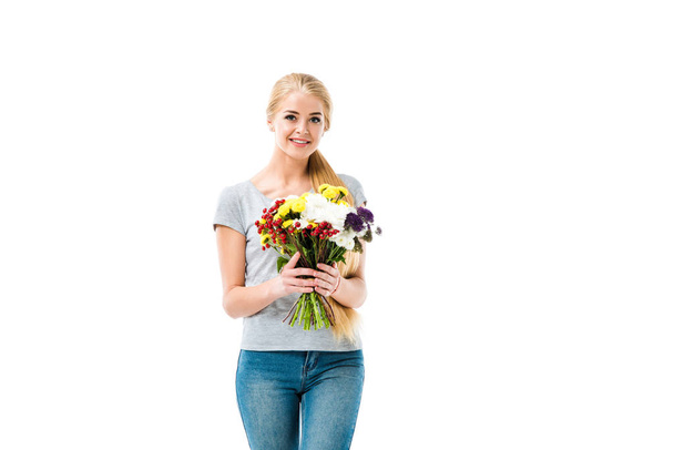 Pretty blonde girl holding flowers and looking at camera - 写真・画像