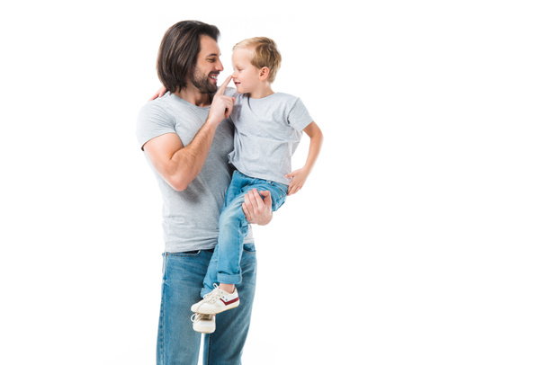 Awesome father hugging, holding and ceressing his son isolated on white - Фото, изображение