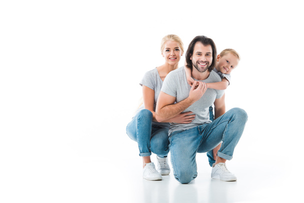 Smiling family hugging together isolated on white  - Foto, Imagem