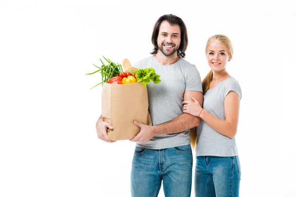 Lovely couple with food bag smiling at camera isolated on white  - Φωτογραφία, εικόνα