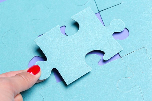 close up of hand holding Puzzle piece on colorful background  - Photo, Image