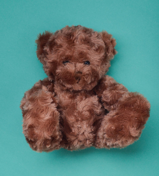 Teddy bear on a blue background. Toys from childhood. - Fotografie, Obrázek