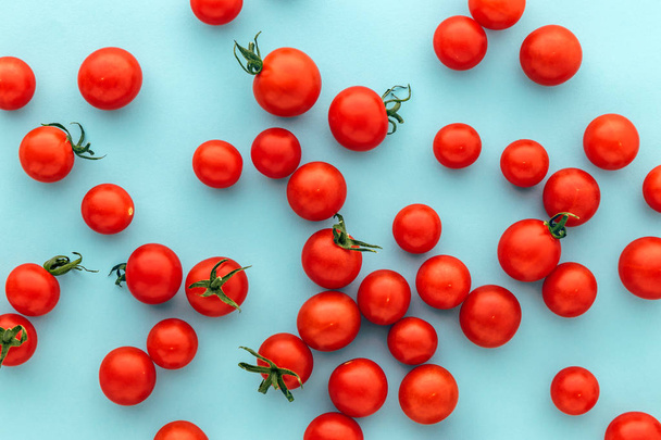 Kolorowe ekologiczne pomidory cherry na niebieskim tle, marmur Red Holland pomidor - Zdjęcie, obraz