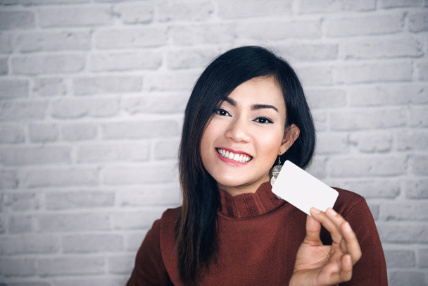 Aasian tyttö nostaa valkoisia kortteja ja hyvä .Focus kasvot
 - Valokuva, kuva