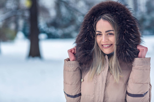 Hymyilevä nuori nainen talvella ulkona. talvi lumi päivä
 - Valokuva, kuva