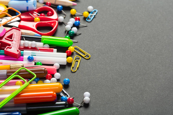 Different colorful stationery on black background - Photo, image