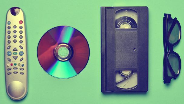 Remote from the TV, 3d glasses, CD drive, vhs on mint color pastel background. Retro technology. - Photo, Image