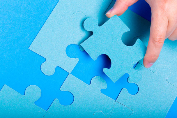 close up of hand holding Puzzle piece on colorful background  - Φωτογραφία, εικόνα