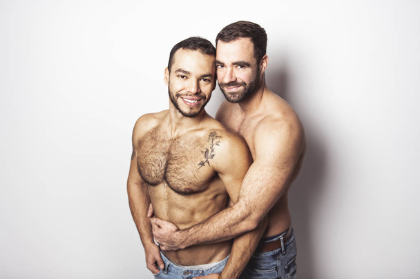 Young homosexuals gay couple love each other on a white background. - Foto, immagini