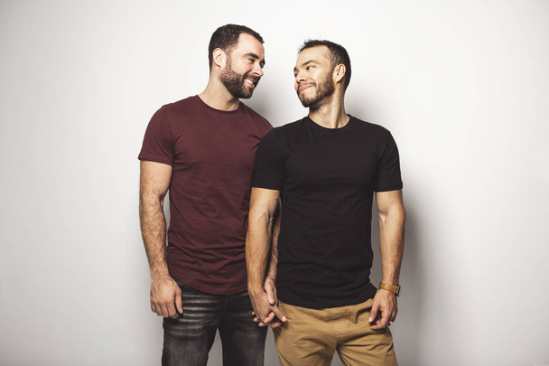 Young homosexuals gay couple love each other on a white background. - Foto, Bild