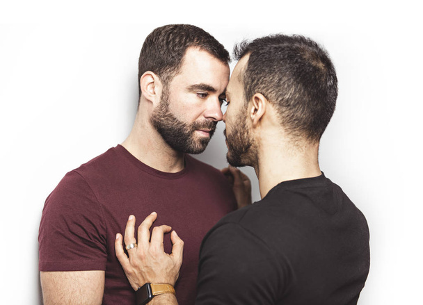 Young homosexuals gay couple love each other on a white background. - Foto, immagini