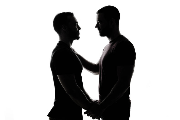 Fiatal homoszexuálisok árnyék pár szeretik egymást, egy fehér háttér. - Fotó, kép