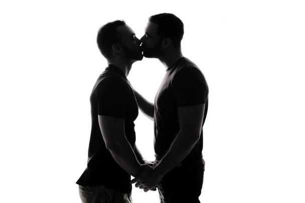 Young homosexuals shadow couple love each other on a white background. - Fotó, kép