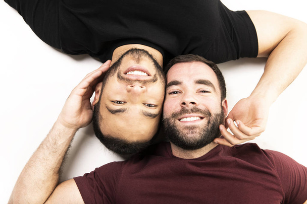 Young homosexuals gay couple love each other on a white background. - Φωτογραφία, εικόνα