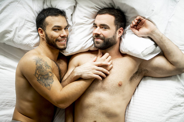 A Handsome gay men couple on bed together - 写真・画像