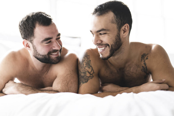 A Handsome gay men couple on bed together - Fotografie, Obrázek