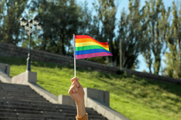 Woman holding rainbow LGBT flag outdoors - Photo, Image