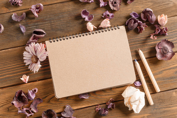 Blank notebook with flowers on vintage wooden table - Fotoğraf, Görsel