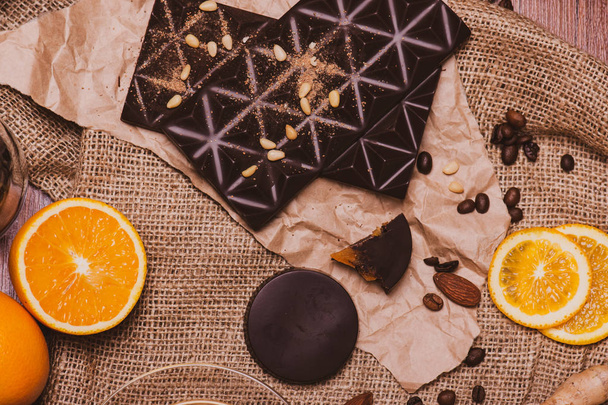 Chocolate, cinnamon, orange, nuts, coffee on burlap. - Foto, afbeelding