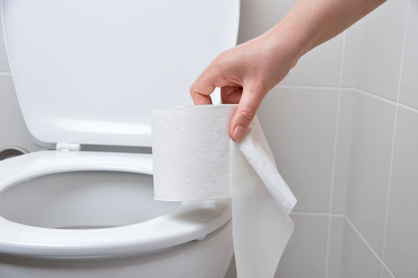 close-up of a woman hand using toilet paper - Φωτογραφία, εικόνα