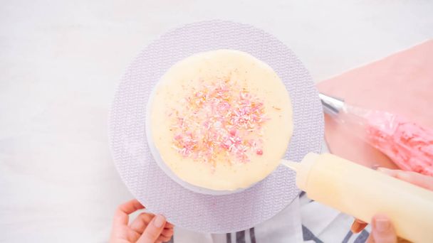 Step by step. Flat lay. Decorating tall birthday cake with a pink sprinkles. - Fotografie, Obrázek