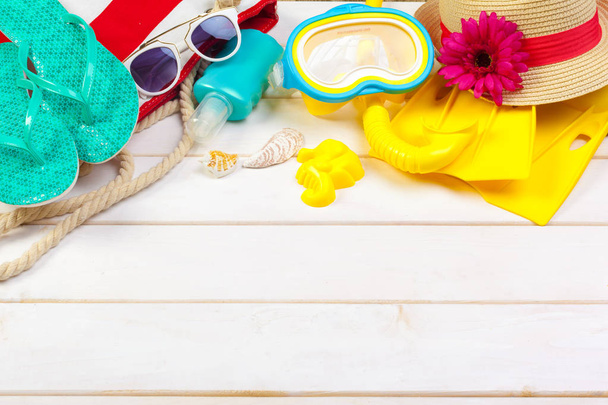 Beachwear and accessories on a white wooden background - Фото, зображення