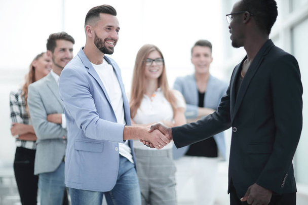 Business team of several people, mens shaking hands and smiling. - Foto, afbeelding